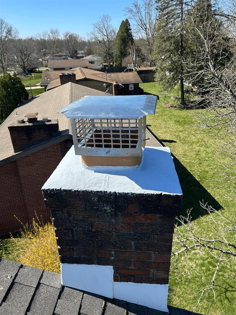 Chimney crown sealed with a waterproof crown coating and a new stainless steel cap after repair in Pittsburgh