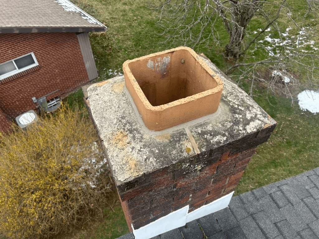 Cracked concrete chimney crown on a Pittsburgh chimney letting water into the structure