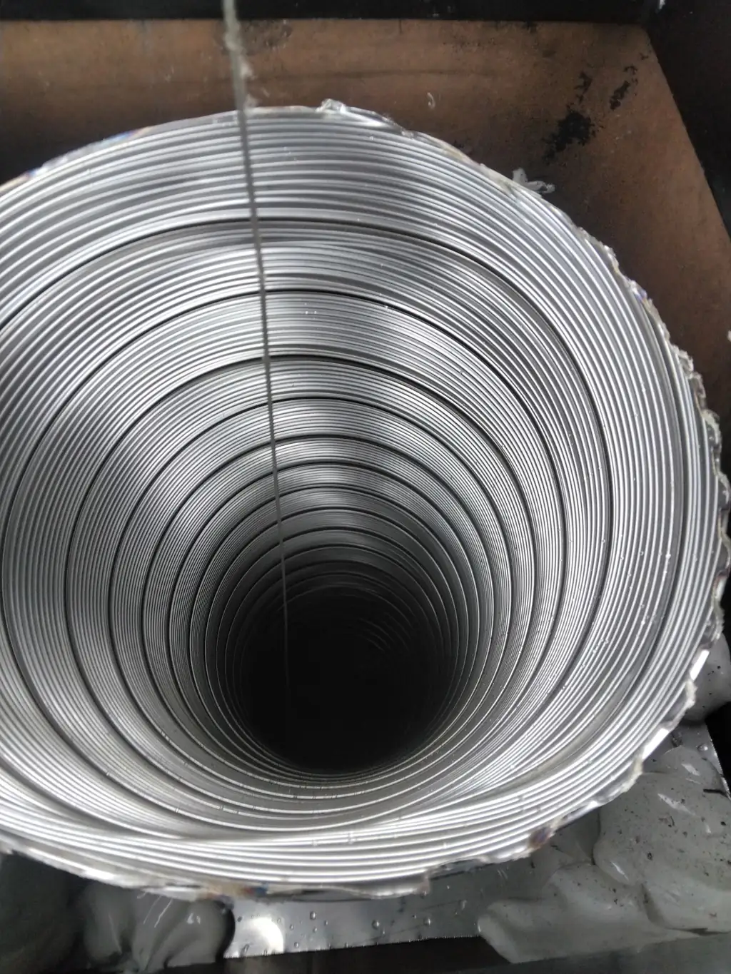 Looking down the new stainless steel liner installed in a Bethel Park, PA fireplace flue