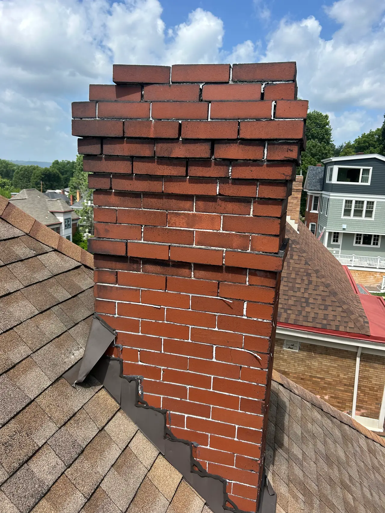 Spalling brick faces and deteriorated mortar joints on a water damaged Pittsburgh chimney