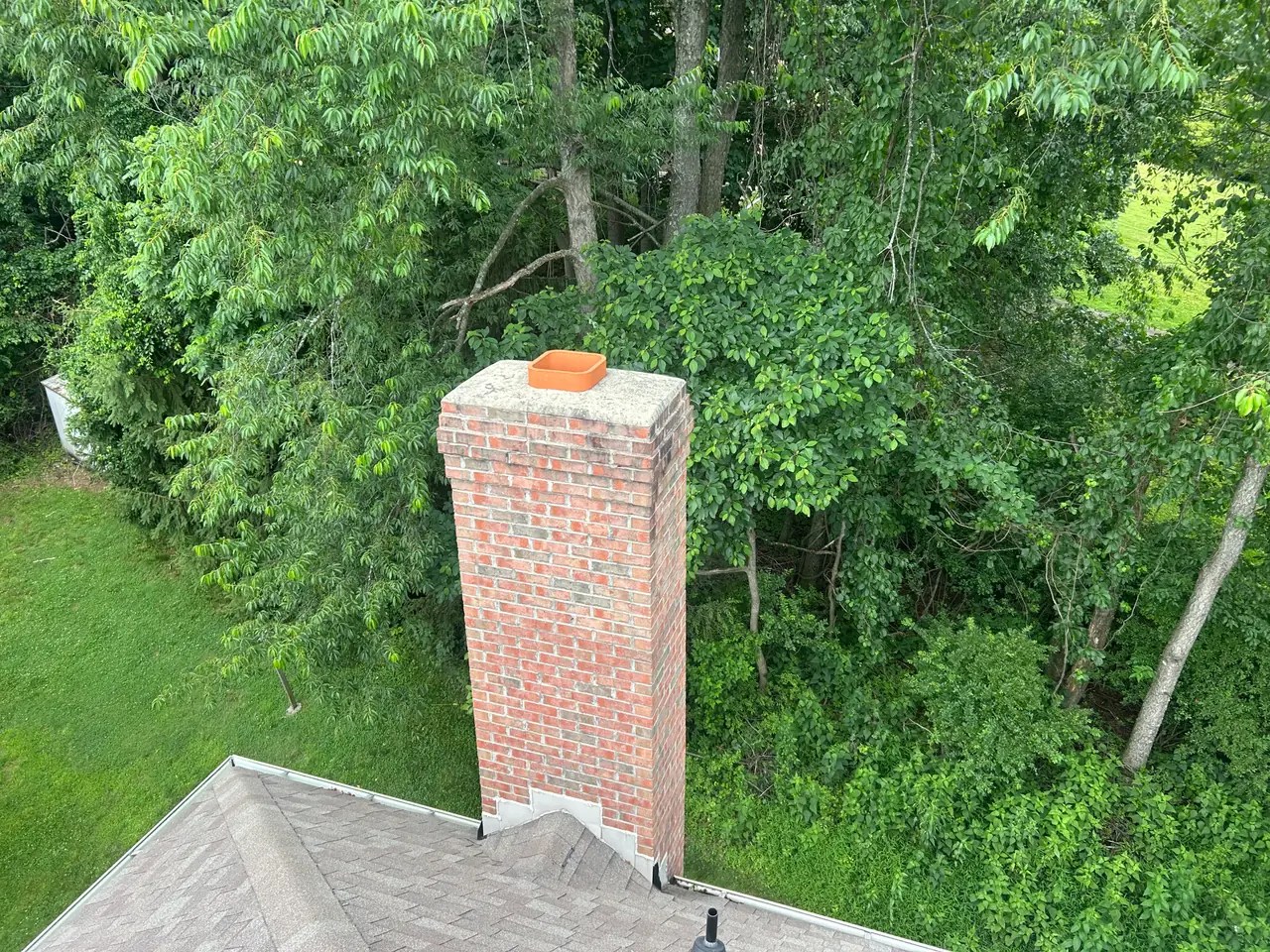 Open uncapped chimney flue on a Pittsburgh area home letting rain fall directly down the chimney