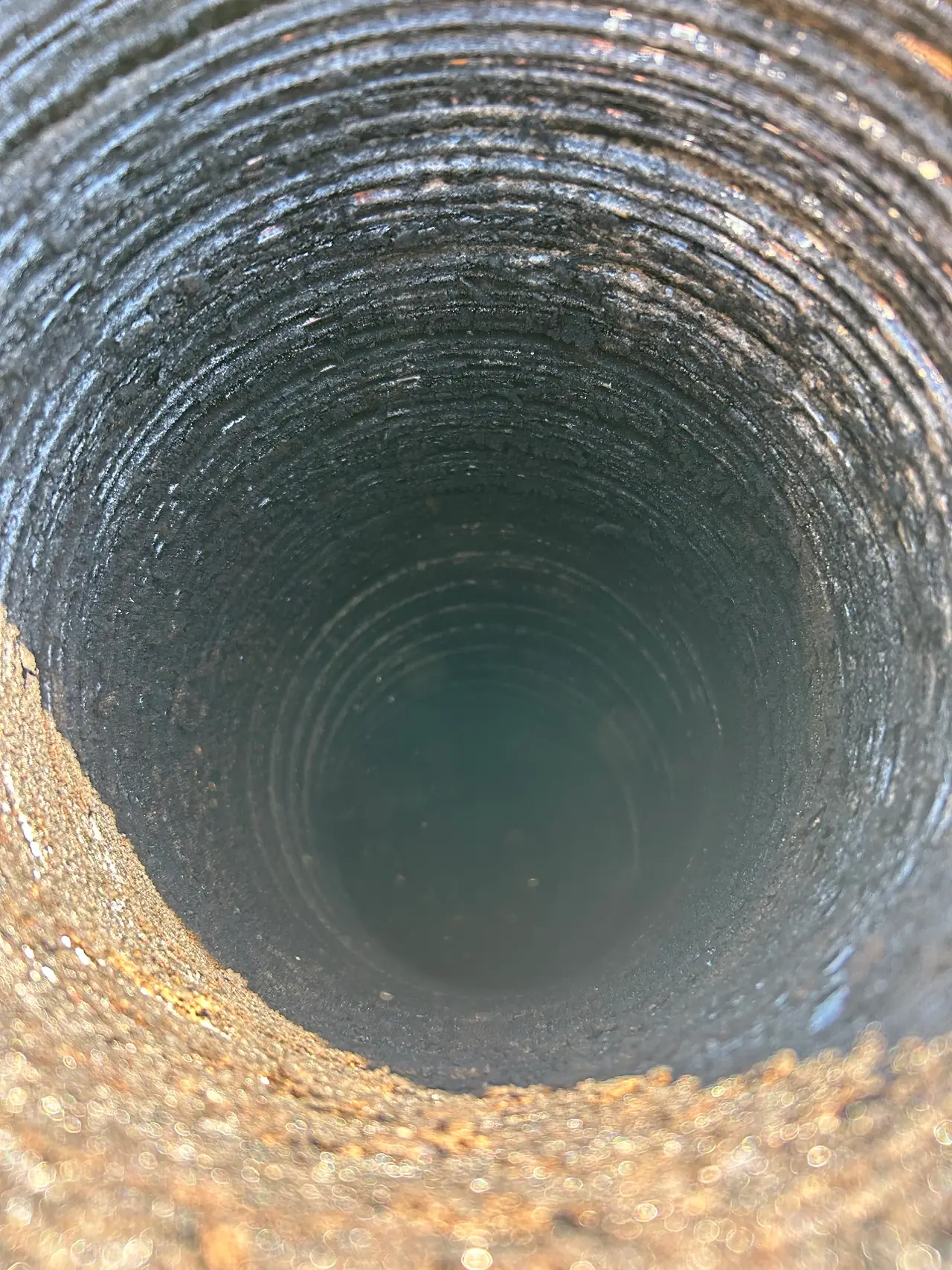 Stage two creosote buildup lining a round metal chimney liner on a Pittsburgh home